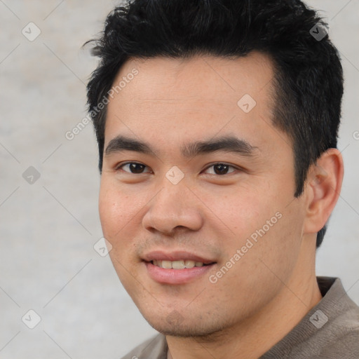 Joyful asian young-adult male with short  black hair and brown eyes