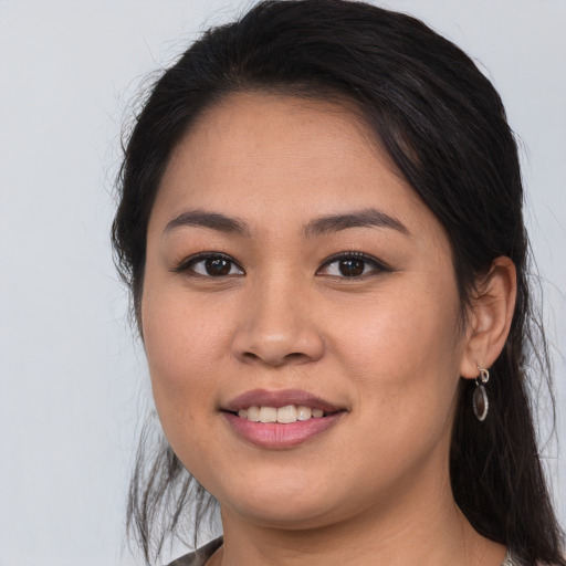 Joyful white young-adult female with long  brown hair and brown eyes