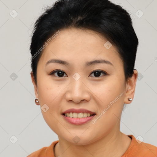 Joyful asian young-adult female with short  brown hair and brown eyes