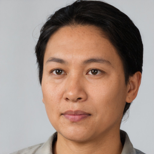 Joyful asian adult female with short  black hair and brown eyes