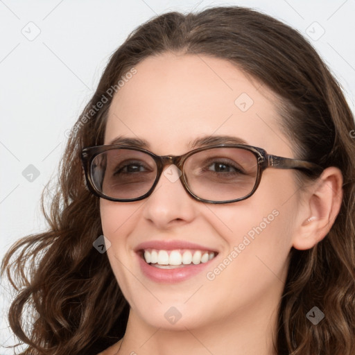 Joyful white young-adult female with long  brown hair and blue eyes