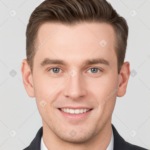 Joyful white young-adult male with short  brown hair and grey eyes