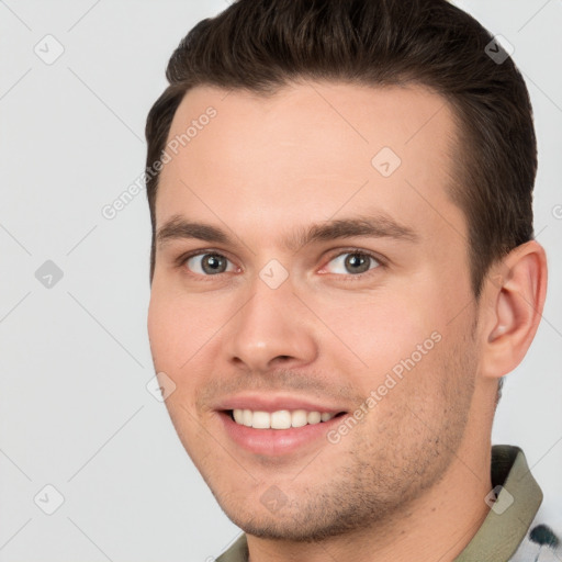 Joyful white young-adult male with short  brown hair and brown eyes