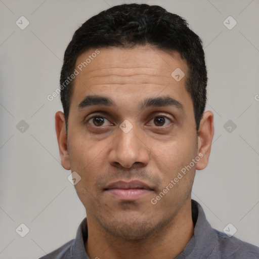 Joyful latino young-adult male with short  black hair and brown eyes