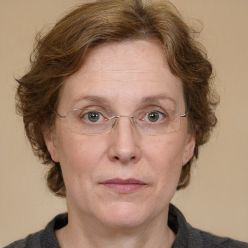 Joyful white adult female with medium  brown hair and blue eyes