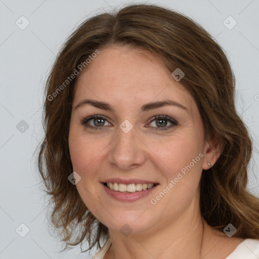 Joyful white young-adult female with long  brown hair and green eyes