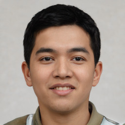 Joyful white young-adult male with short  black hair and brown eyes