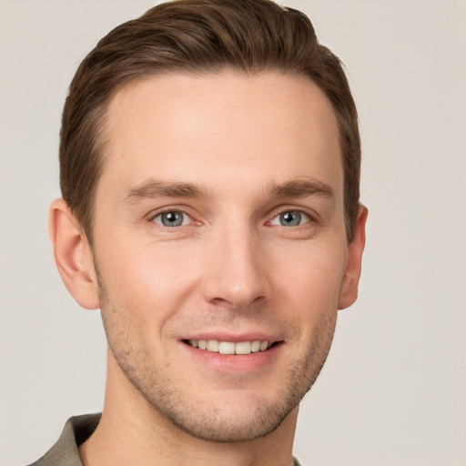 Joyful white young-adult male with short  brown hair and grey eyes