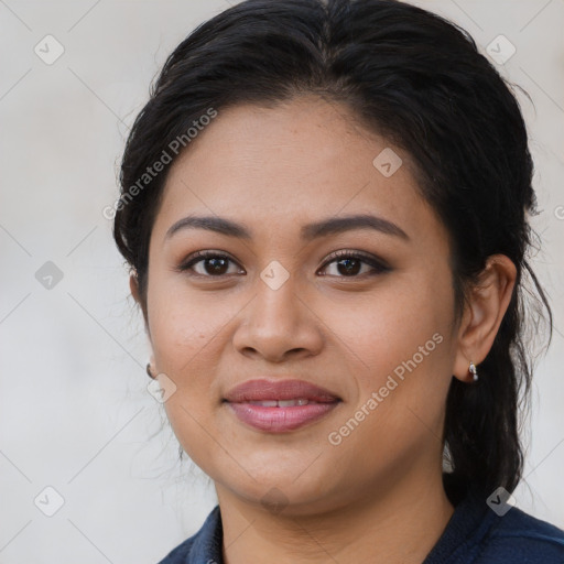 Joyful latino young-adult female with long  brown hair and brown eyes