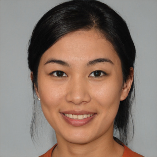 Joyful asian young-adult female with medium  brown hair and brown eyes