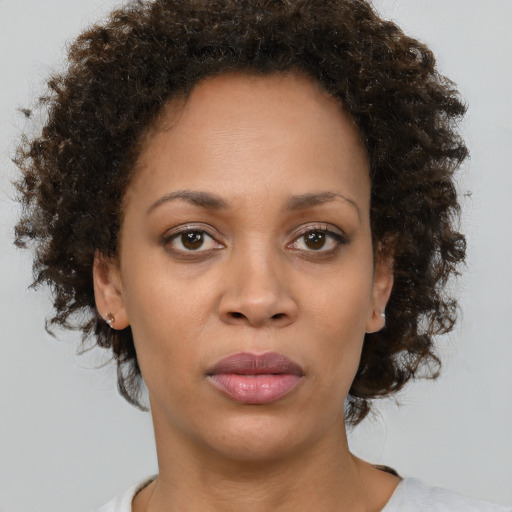 Joyful black adult female with short  brown hair and brown eyes