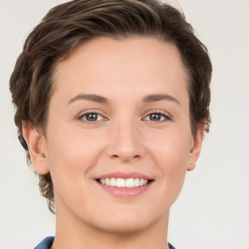 Joyful white young-adult female with short  brown hair and grey eyes