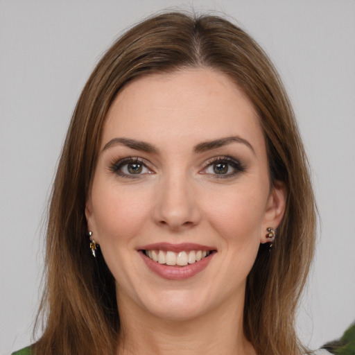 Joyful white young-adult female with long  brown hair and green eyes