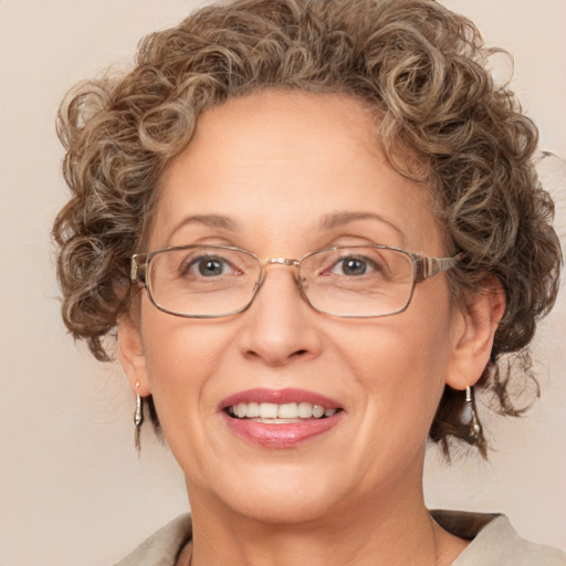 Joyful white adult female with medium  brown hair and blue eyes