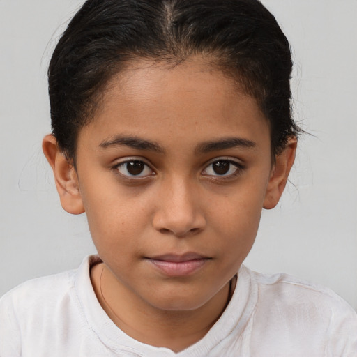Joyful latino child female with short  brown hair and brown eyes