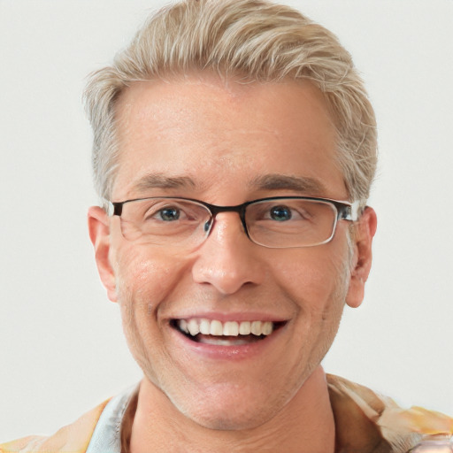 Joyful white adult male with short  blond hair and blue eyes