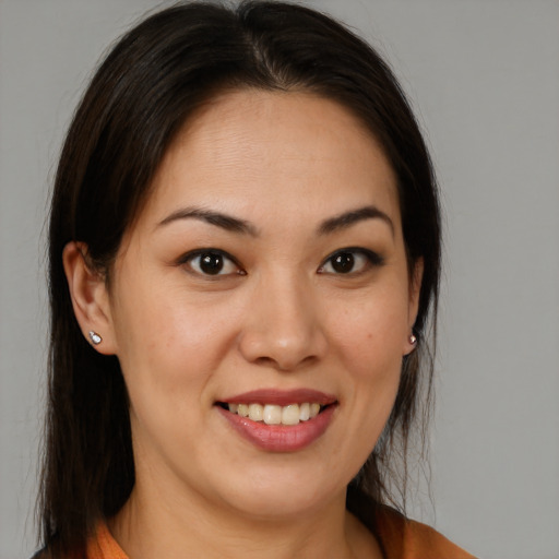 Joyful latino young-adult female with medium  brown hair and brown eyes