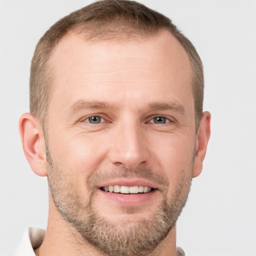 Joyful white adult male with short  brown hair and grey eyes