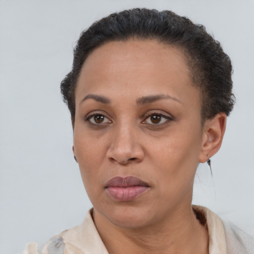 Joyful latino adult female with short  brown hair and brown eyes