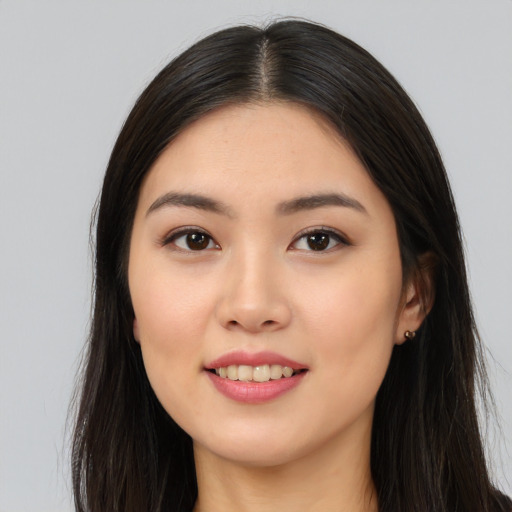 Joyful asian young-adult female with long  black hair and brown eyes