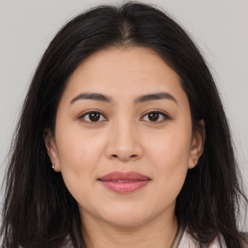 Joyful latino young-adult female with long  brown hair and brown eyes