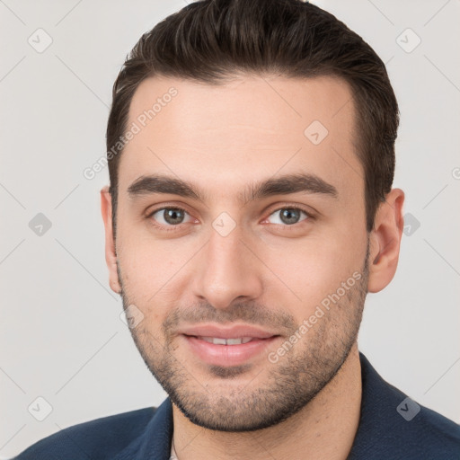 Joyful white young-adult male with short  brown hair and brown eyes