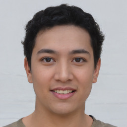 Joyful asian young-adult male with short  brown hair and brown eyes