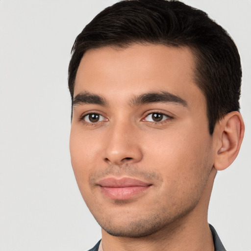 Joyful white young-adult male with short  black hair and brown eyes