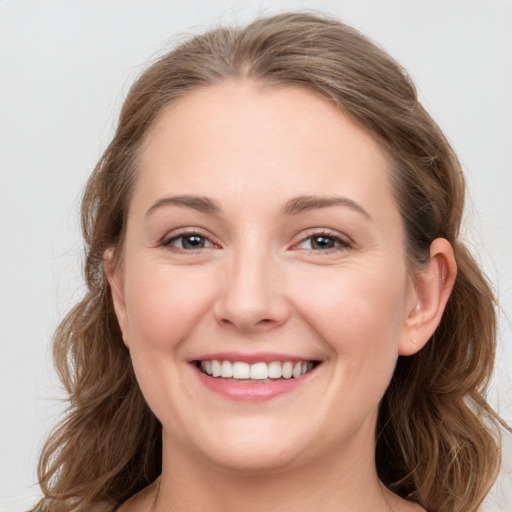 Joyful white young-adult female with long  brown hair and grey eyes