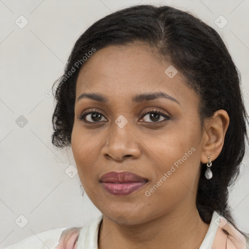 Joyful black young-adult female with medium  brown hair and brown eyes