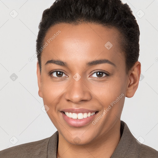 Joyful black young-adult female with short  brown hair and brown eyes