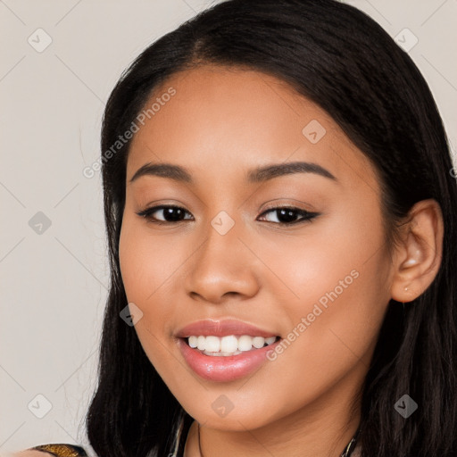 Joyful latino young-adult female with long  black hair and brown eyes