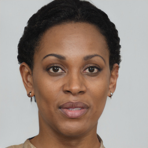 Joyful black adult female with short  black hair and brown eyes