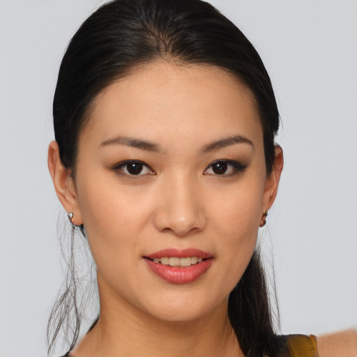 Joyful asian young-adult female with medium  brown hair and brown eyes