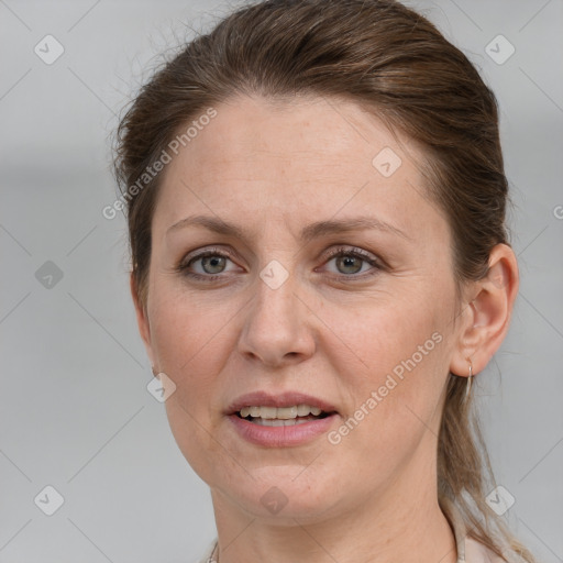 Joyful white adult female with medium  brown hair and grey eyes