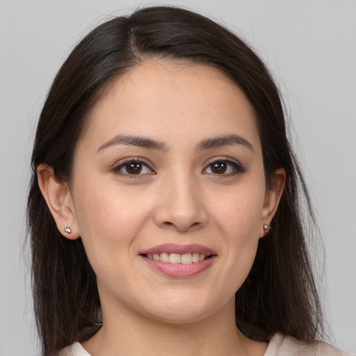 Joyful white young-adult female with long  brown hair and brown eyes