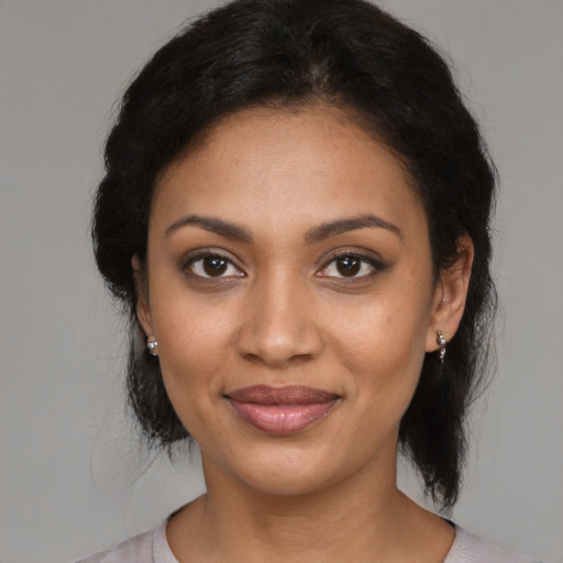 Joyful black young-adult female with medium  brown hair and brown eyes