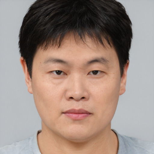 Neutral asian young-adult male with short  brown hair and brown eyes