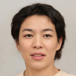 Joyful asian young-adult female with short  brown hair and brown eyes