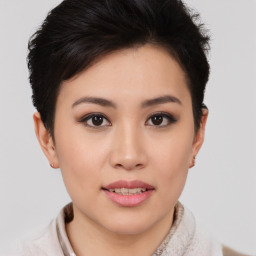 Joyful asian young-adult female with short  brown hair and brown eyes