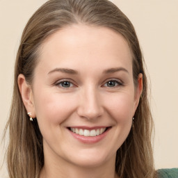 Joyful white young-adult female with long  brown hair and grey eyes