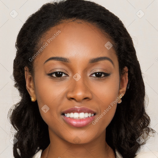 Joyful black young-adult female with long  brown hair and brown eyes