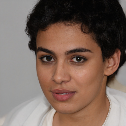 Joyful latino young-adult female with short  brown hair and brown eyes