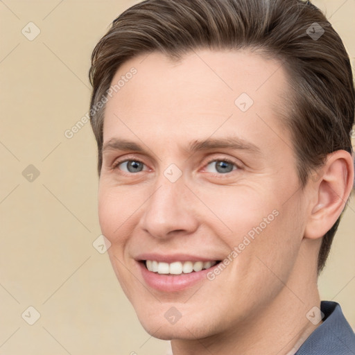 Joyful white young-adult male with short  brown hair and grey eyes