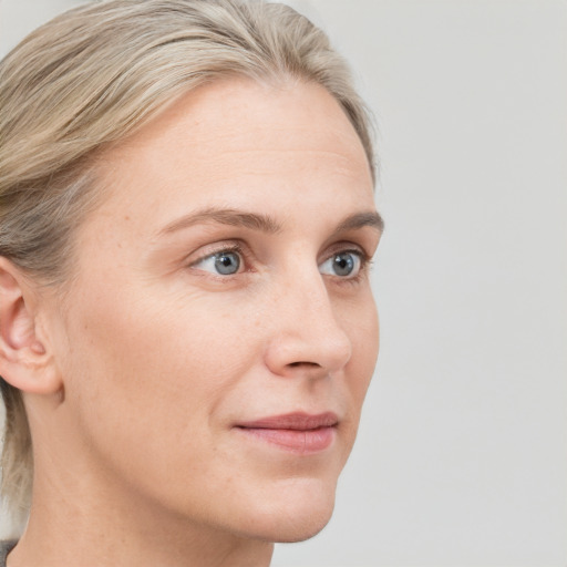 Neutral white young-adult female with short  brown hair and blue eyes