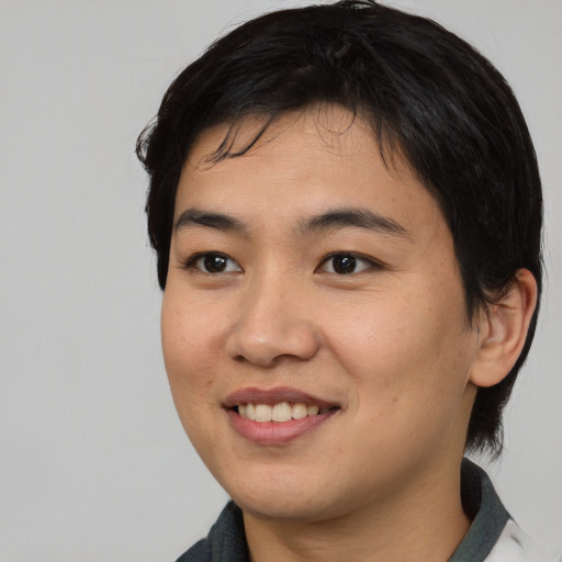 Joyful asian young-adult female with medium  black hair and brown eyes