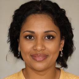 Joyful black young-adult female with medium  brown hair and brown eyes