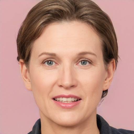 Joyful white adult female with medium  brown hair and grey eyes