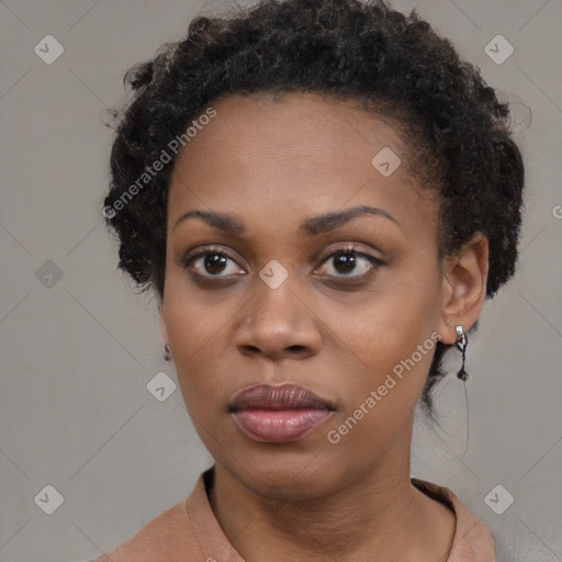 Joyful black young-adult female with short  black hair and brown eyes