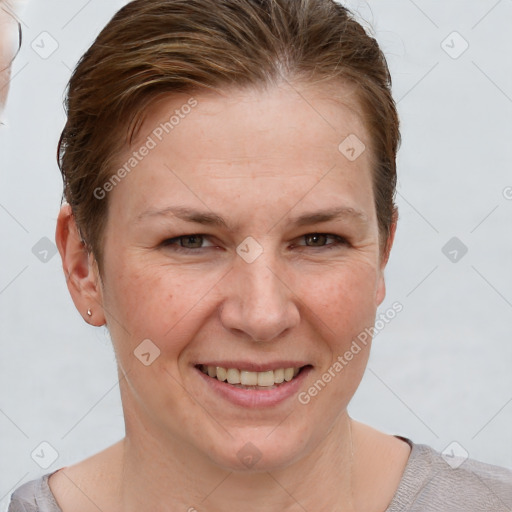 Joyful white adult female with short  brown hair and grey eyes